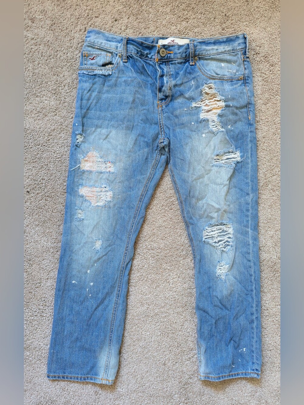 Medium-wash Hollister distressed and paint-splattered jeans